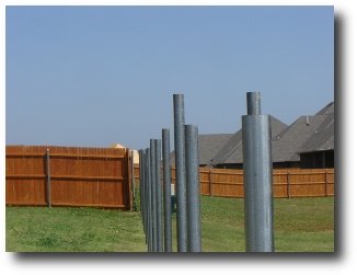 Badly installed galvanized fence post.