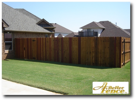 Stained solid board fence design, with cedar pickets