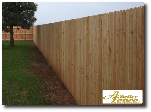 An unstained solid board fence 